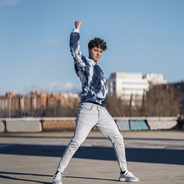 Stock photo of cool boy doing dance moves and having fun.